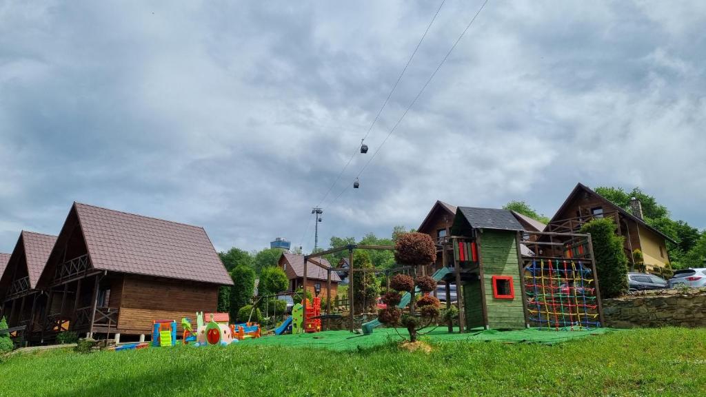 a person is flying a kite in a playground at La Merveille in Solina