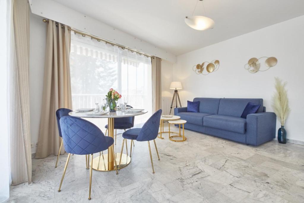 uma sala de estar com um sofá azul e uma mesa em Cannes centre-Palais-200m des plages em Cannes