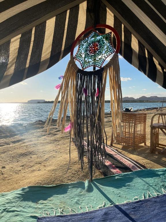 a dream catcher hanging from a beach umbrella at Mbiama Resort in Siwa