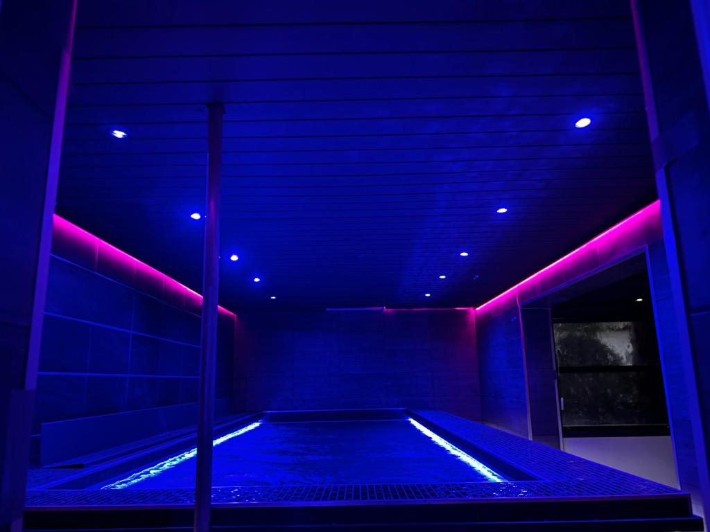a room with a hot tub with purple lights at Mas La Farelle Chambre d&#39;hote,Fitness &amp; Salle de jeux Gratuite &amp; SPA en supplément in Nîmes