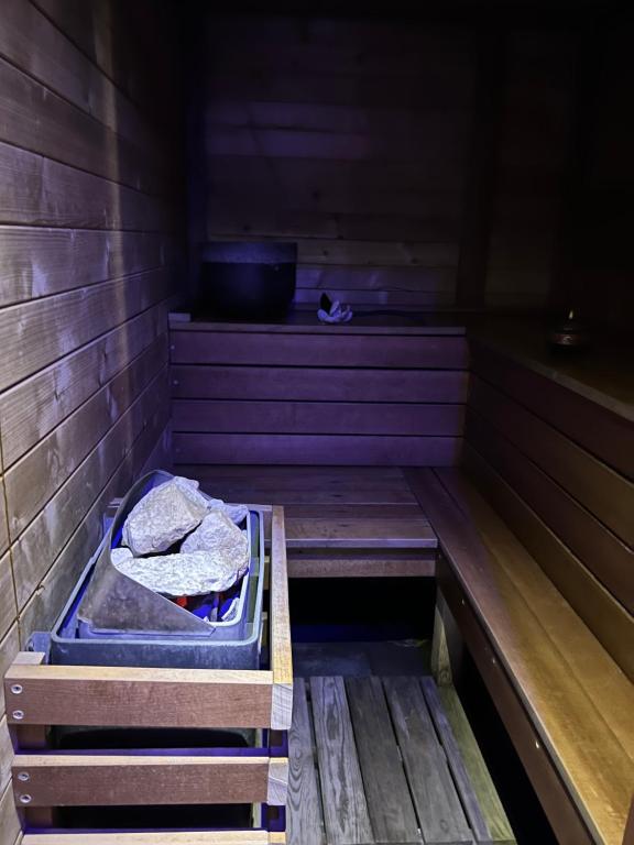 a sauna with a bench and a bowl on top at Mas La Farelle Chambre d&#39;hote,Fitness &amp; Salle de jeux Gratuite &amp; SPA en supplément in Nîmes