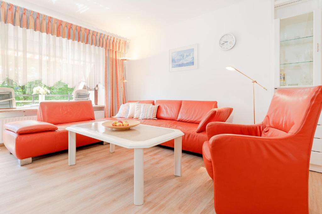 sala de estar con sofá, mesa y 2 sillas en Kastanienallee 3 Wohnung 7, en Timmendorfer Strand