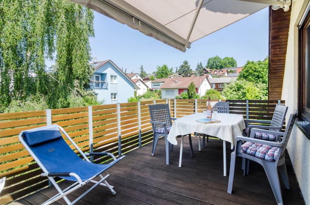 a patio with a table and chairs on a deck at Jaulneau in Owingen