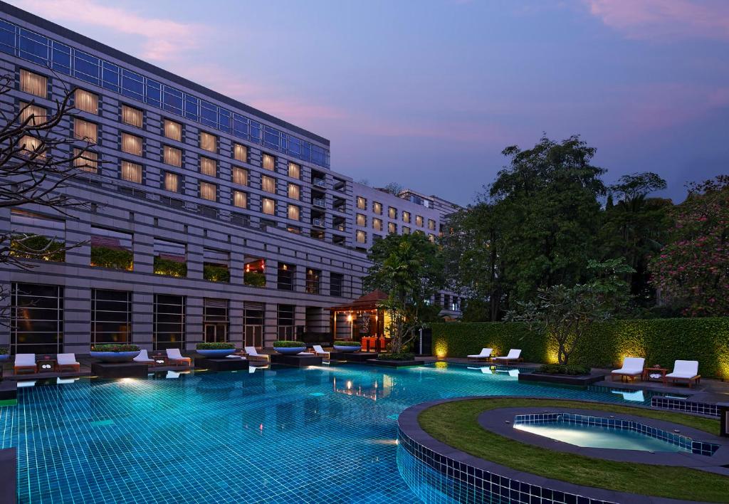 a hotel with a swimming pool in front of a building at Grand Hyatt Mumbai Hotel and Residences in Mumbai