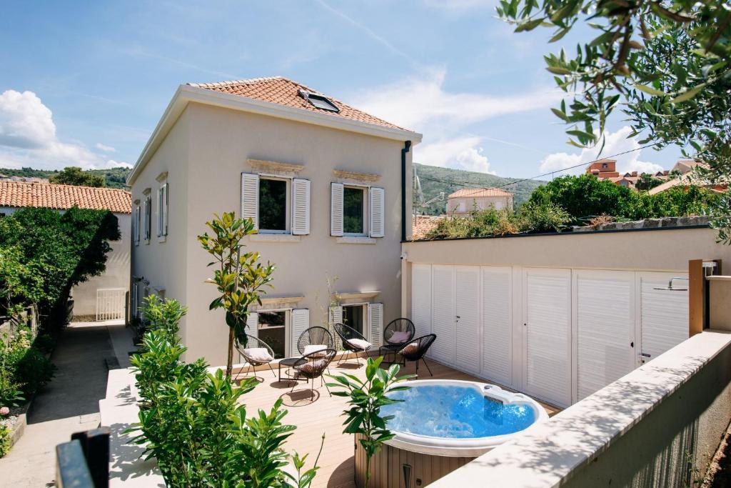 a house with a jacuzzi tub on a patio at KALA LUXURY ROOMS by DuHomes in Dubrovnik