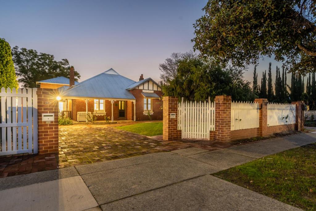 a white fence in front of a house at Picture Perfect Create timeless treasures in Perth