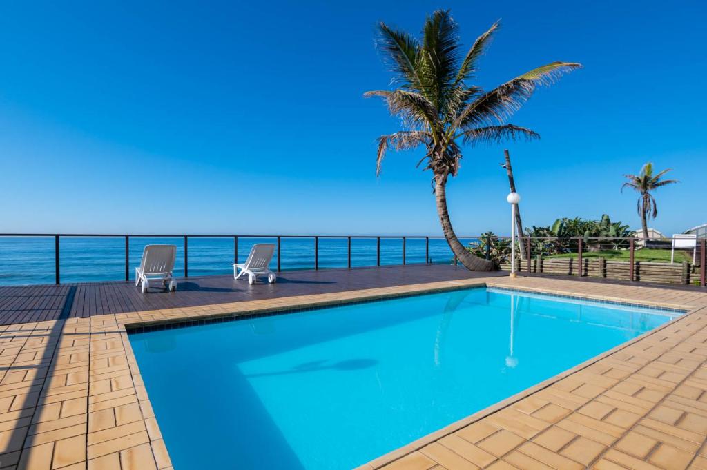 a swimming pool with a view of the ocean at Pebble Beach 26 in Ballito