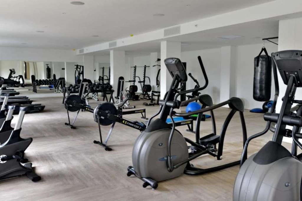 a gym with a bunch of exercise bikes in it at Modern 1BR APT Near Sandton City No Loadshedding in Johannesburg