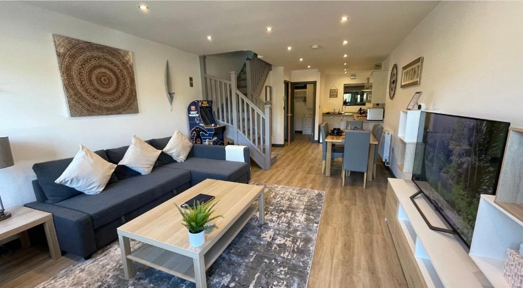 a living room with a blue couch and a table at 3 chapel row cottages in Wirksworth