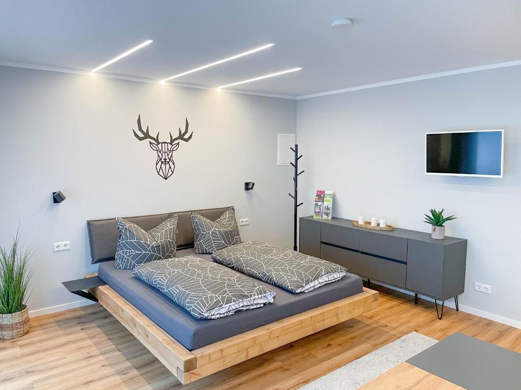 a bedroom with a bed and a tv on a wall at Appartement am Mythenweg in Thale