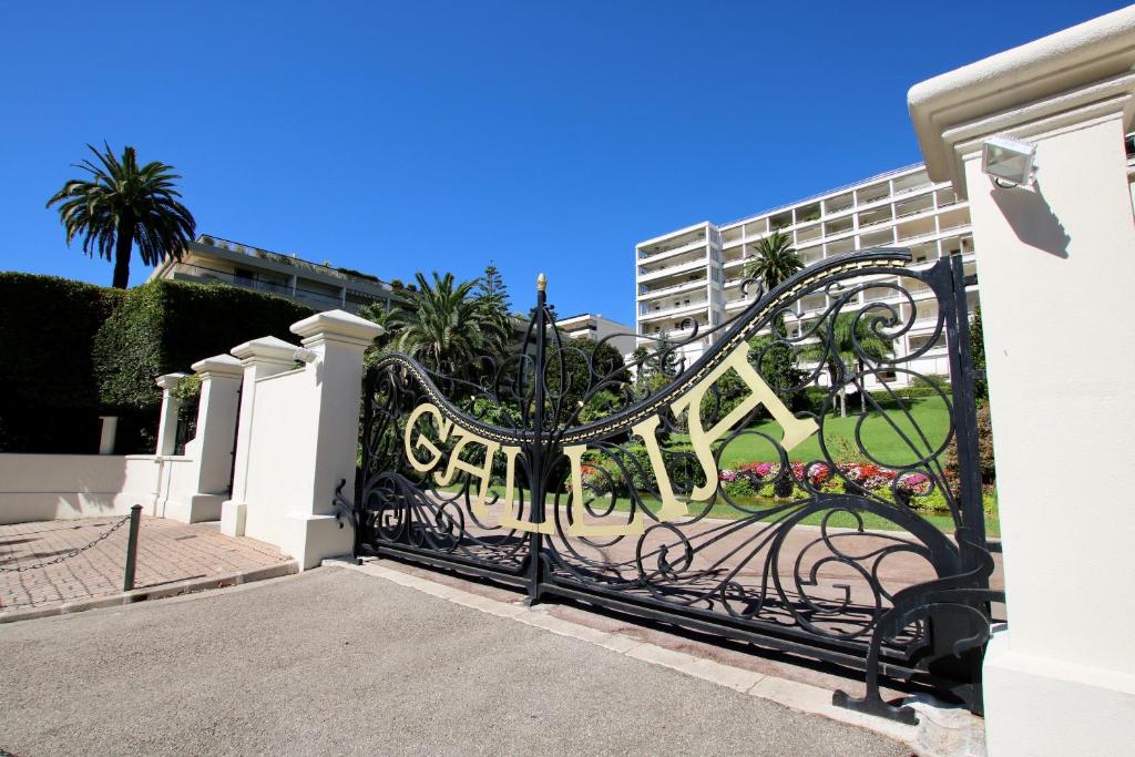 a black wrought iron gate in front of a building at Gallia Blue By SCLS Locations in Cannes