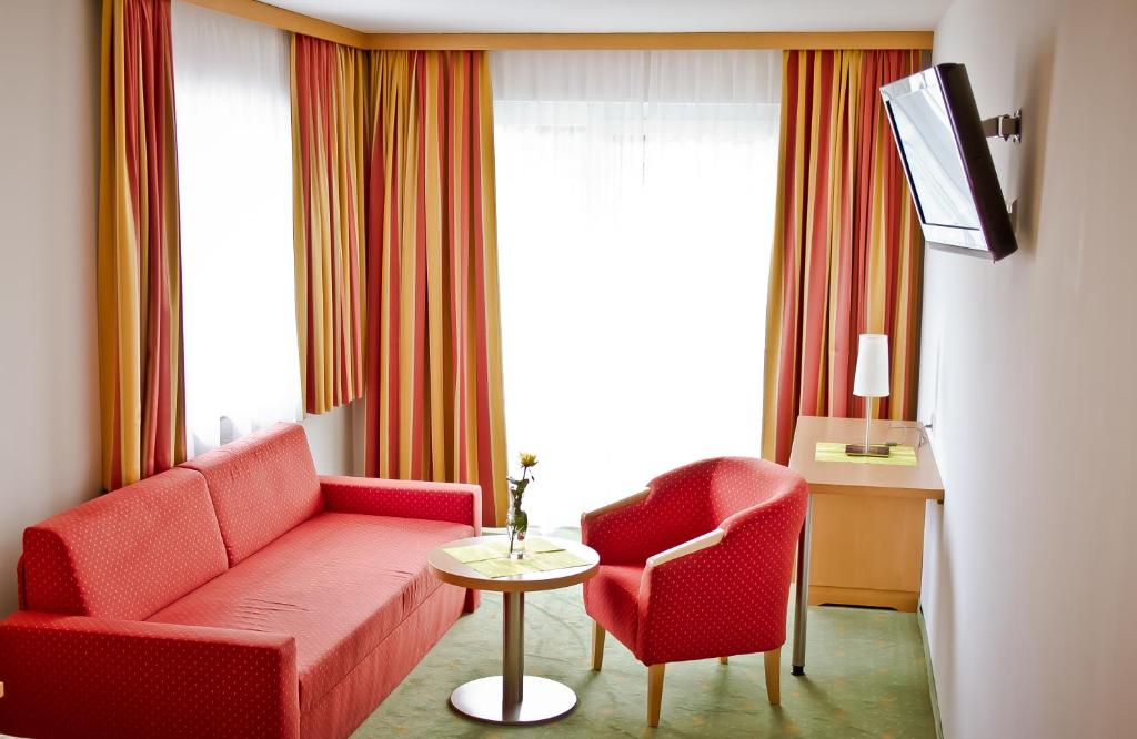 a living room with a couch and two chairs and a table at Der Thomashof in Sankt Jakob im Rosental