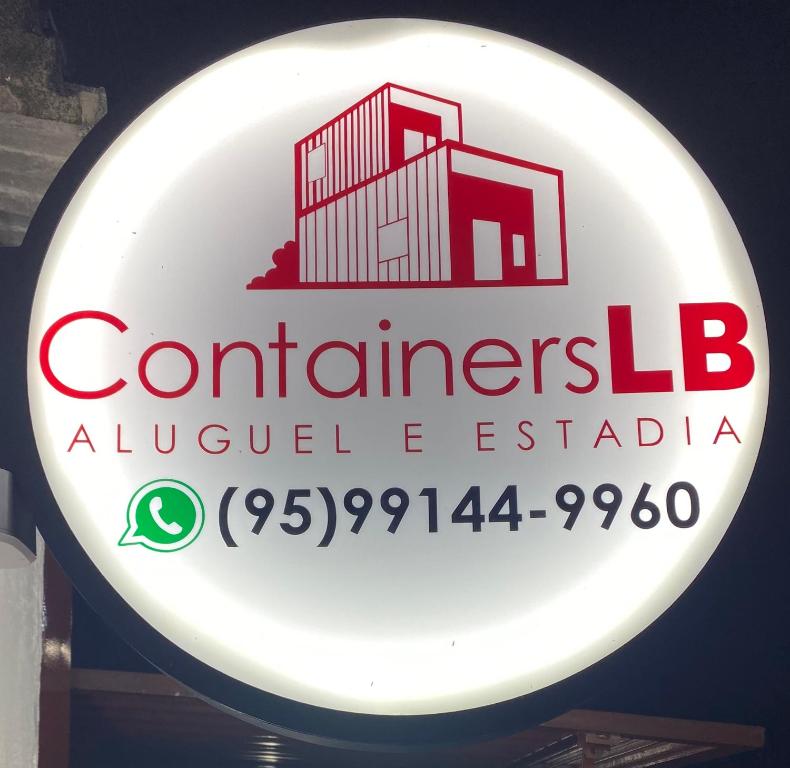 - un panneau indiquant un restaurant avec un bâtiment dans l'établissement Container LB PONU, à Boa Vista