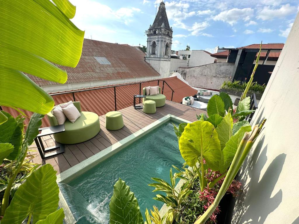 a swimming pool on the roof of a building at AmazINN Places Hotel Boutique Casa Marichu in Panama City