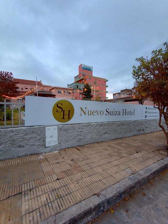 a sign for the niveo suka hotel at Nuevo Suiza Hotel in Villa Carlos Paz