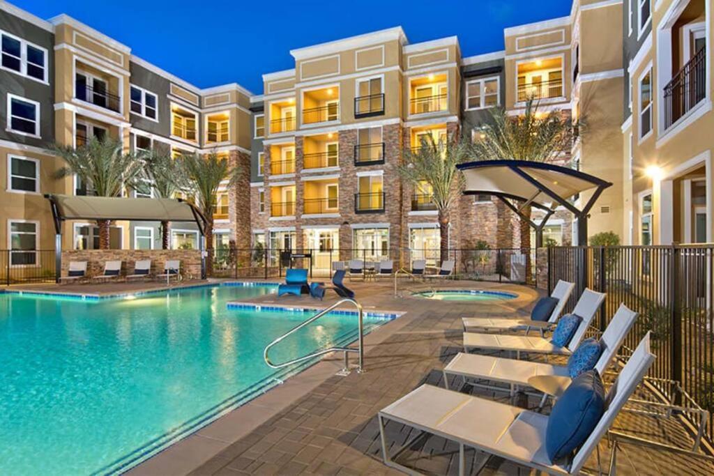 a pool at a apartment complex with chairs and a hotel at Sunny 2BDR 5 min to SM Pool and Gym Free Parking in Los Angeles