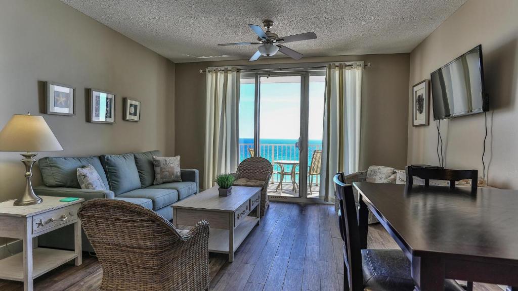 a living room with a couch and a table at Majestic Sun 1006B in Destin