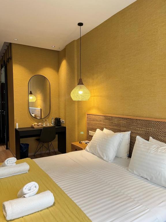 G&W Luxury Rooms tesisinde bir odada yatak veya yataklar