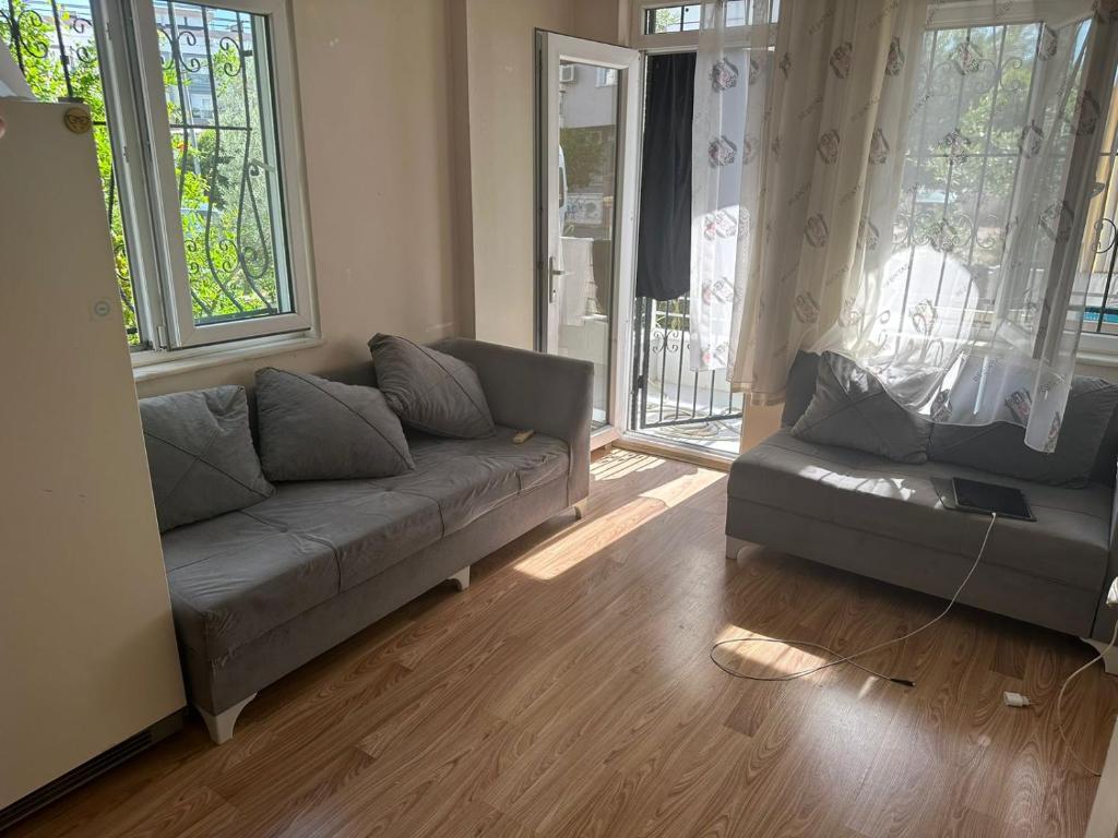 a living room with a couch and two windows at Квартира в Kultur 2+1 in Antalya