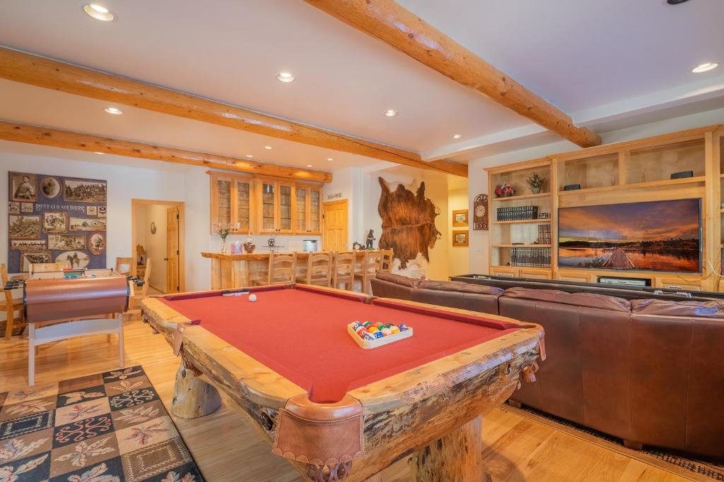 a living room with a pool table in it at Bearfoot Bungalow - Premium and spacious home close to the National Forest and The Village! in Big Bear Lake