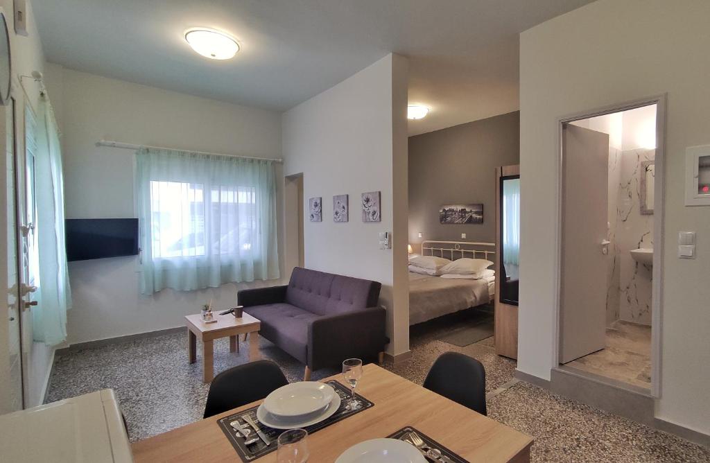 a living room with a couch and a table at GARNET 3 in Kalamata