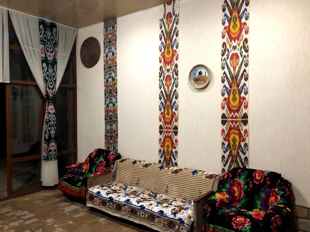 a living room with a couch and two chairs at Shahina tur service in Samarkand
