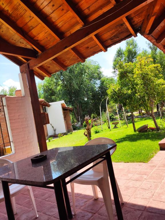 einen Tisch auf einer Terrasse mit Blick auf den Hof in der Unterkunft Molle in Villa Cura Brochero