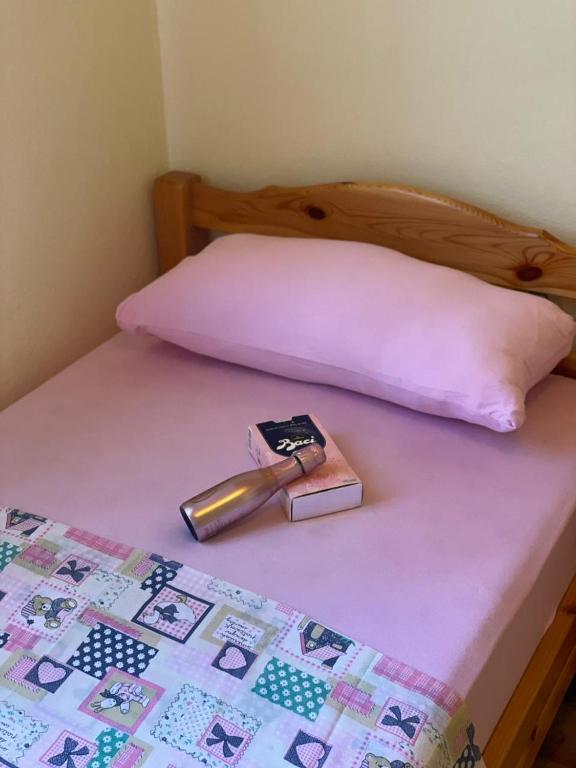 a wooden bed with a thermometer on top of it at DOLCE NOTTE rooms in Virpazar