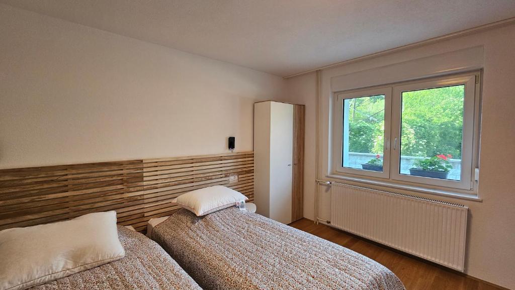 a bedroom with two beds and a window at Apartma Sava-Stol in Jesenice