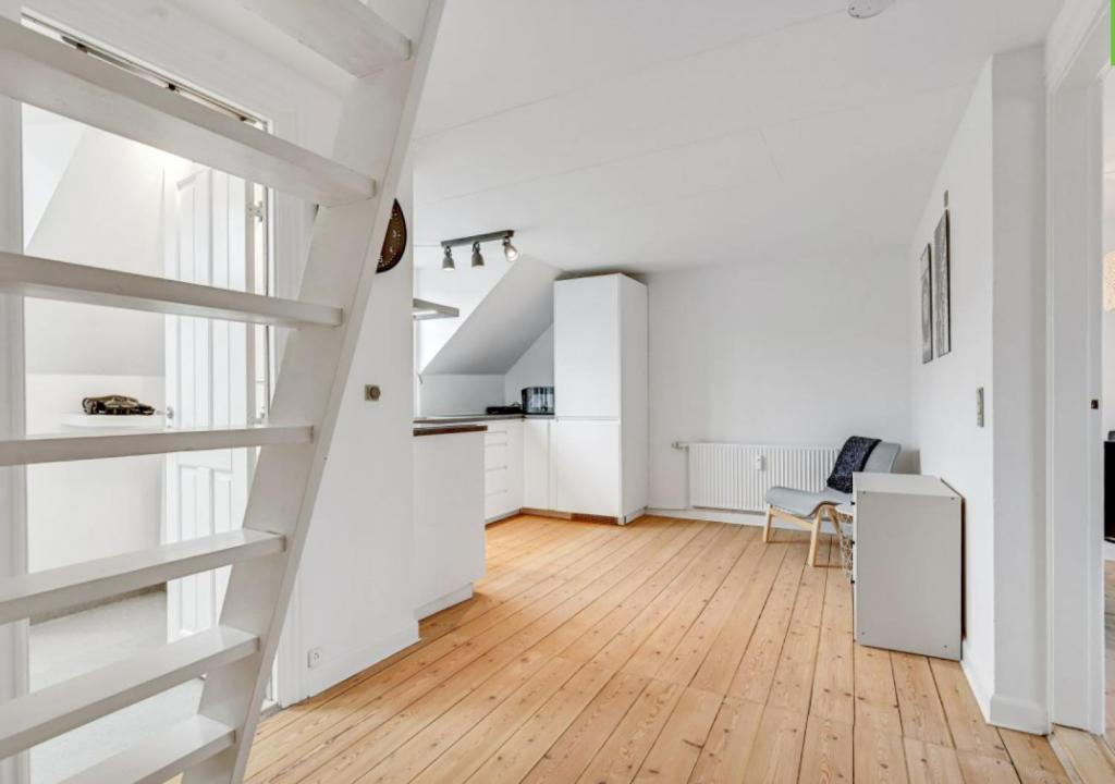 a white apartment with white walls and wooden floors at One Bedroom Apartment In Aarhus, Ole Rmers Gade 104 in Aarhus