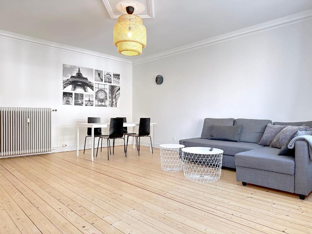 a living room with a couch and a table at Nice Apartment Located Near Vesterbro in Aalborg