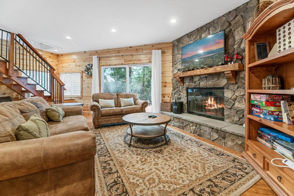 a living room with a couch and a fireplace at Casa Luna- Beautiful Maltby style home, just a short drive from Big Bear's attractions! in Big Bear City