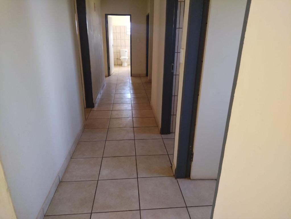 a hallway with a tiled floor in a room at KUNGWINI CENTER in Bronkhorstspruit