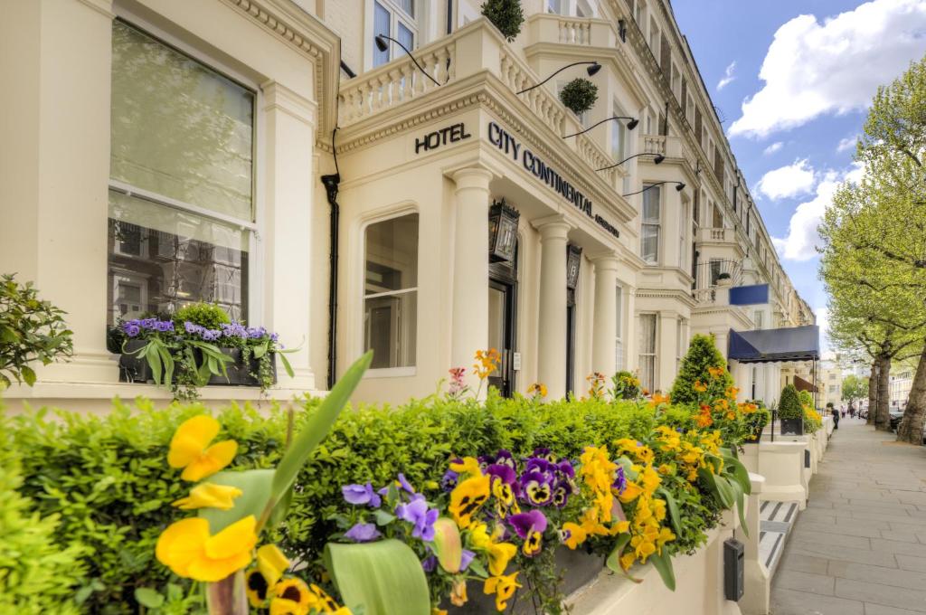 um edifício com flores em frente em City Continental London Kensington em Londres