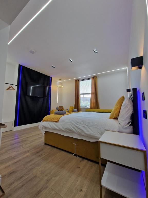 a bedroom with a large bed and a tv at Balco Plaza Studio in Nottingham