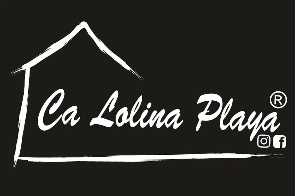 a black and white sign for a la latina plays at Ca Lolina Playa in Gijón