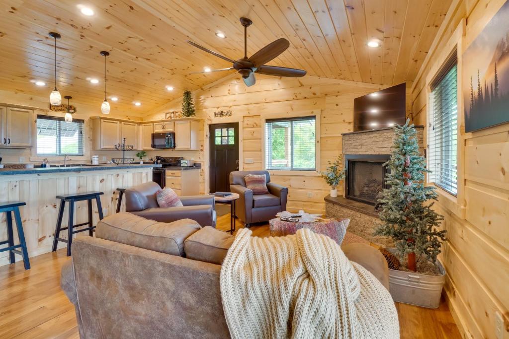 a living room with a couch and a fireplace at Gorgeous Gatlinburg Cabin Large Deck and Hot Tub! in Gatlinburg