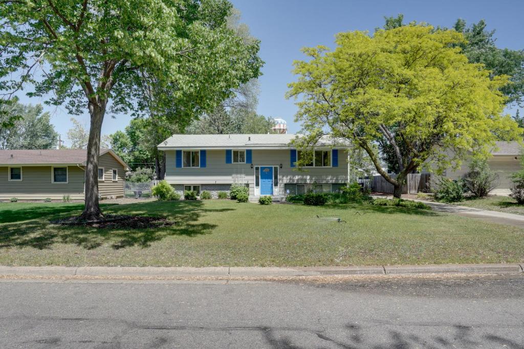 a house with a blue door on a yard at Pet-Friendly Apartment in Minneapolis! in Minneapolis