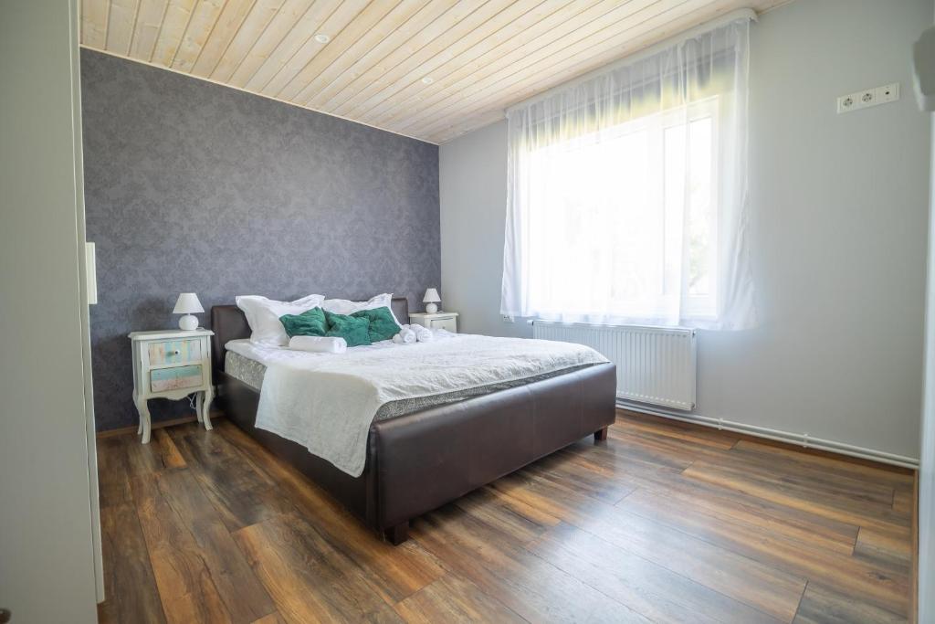 a bedroom with a large bed and a window at Manni's house with garden & playground in Kuressaare