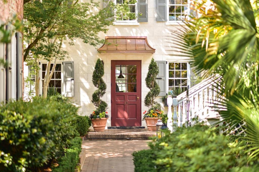 a house with a red door and some plants at Zero George Hotel in Charleston