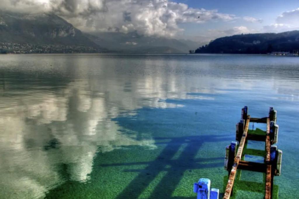 a dock in the middle of a large body of water at Quiet Studio in a House in Sevrier Annecy Lake very close to the lake in Sévrier