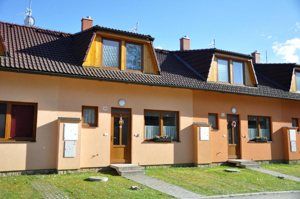 a house with a row of doors and windows at Rekreace na Lipně in Frymburk