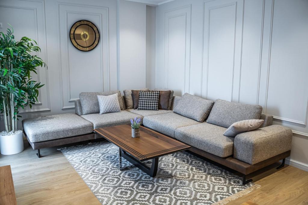 a living room with a couch and a coffee table at Sense Luxury Apartments in Velipojë