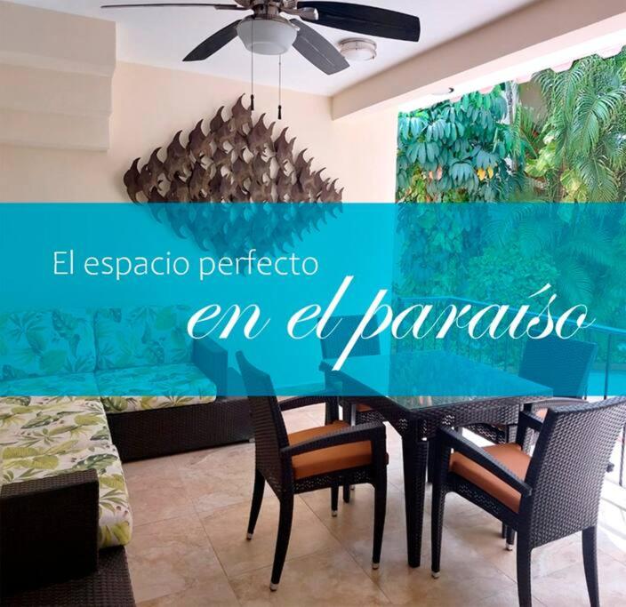 a dining room with a black table and chairs at Villas Cozumel #7 in Cozumel