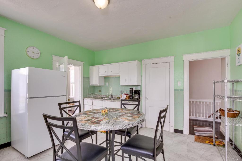 a kitchen with a table and chairs and a white refrigerator at Convenient Jennings Apartment, 12 Mi to St Louis! in Jennings
