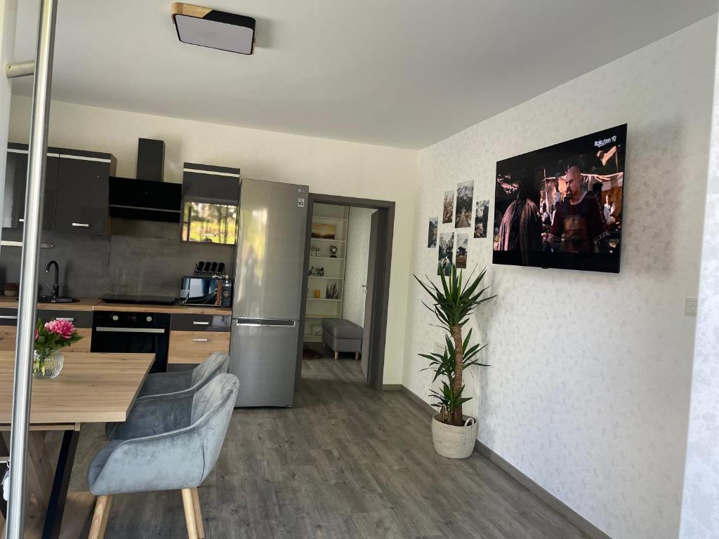 a kitchen with a stainless steel refrigerator and a table at Ferienwohnung in Hünfeld