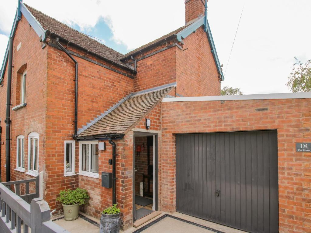 a brick house with a garage at The Ferns in Ludlow