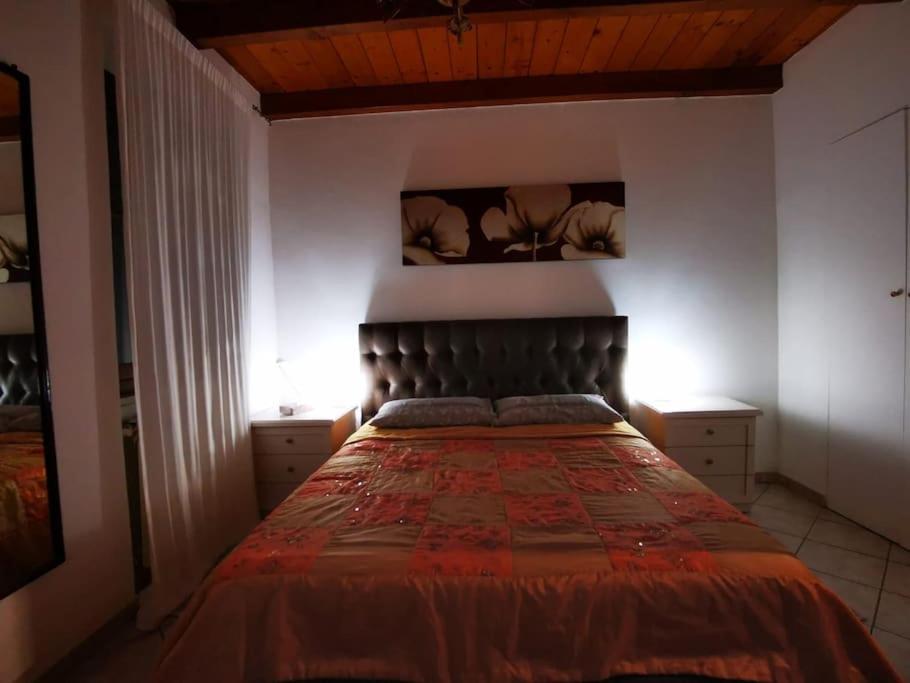 - une chambre avec un lit et une couette rouge dans l'établissement Casa Vacanze a 2 passi dal mare, à Carrara