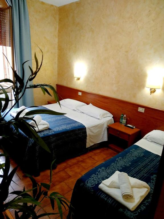 Postel nebo postele na pokoji v ubytování Hotel Ferrari