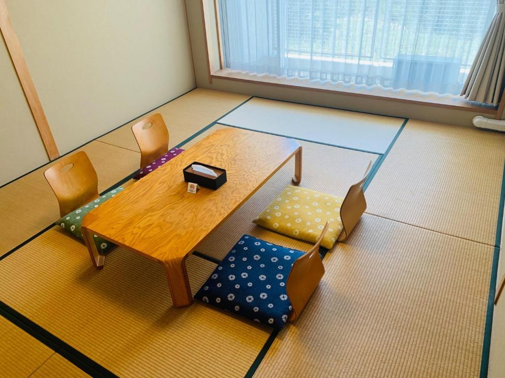 een tafel en stoelen in een kamer bij Starry Sky and Sea of Clouds Hotel Terrace Resort - Vacation STAY 51691v in Takeda